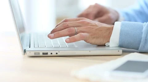 Closeup of man's hand typing on laptop keyboard Stock Footage 49758713