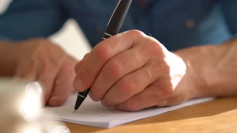 Closeup of man's hand writing on paper with pen Video stock 72010201