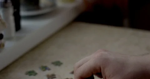 Closeup of mans hands assembling puzzle Video stock 87252623