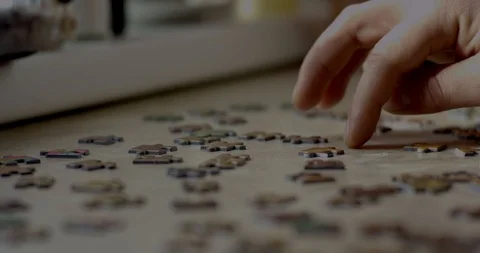 Closeup of mans hands assembling puzzle Stock Footage 87252643