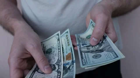 Closeup of man's hands counting dollar cash banknotes Video stock 316920417