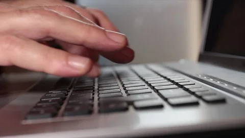 Closeup of man's hands as he writes on the keyboard of a laptop Video stock 120567527