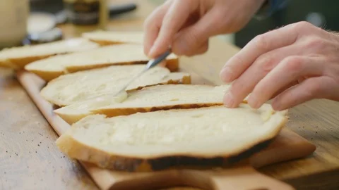 Closeup Of Man's Hands Spreading Butter On Bread Slice Stock Footage 86070394