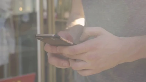 Closeup Of Man's Hands Texting On Smartphone, Sunny Day Outside Of Storefront Stock Footage 75879930