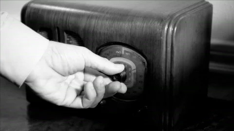 Closeup of a mans hands tuning a vintage radio Stock Footage