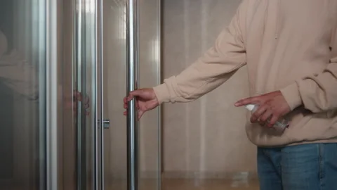 Closeup of man's hands using a sanitizer and a wet towel for desinfection of Stock Footage 136253784