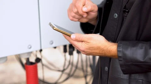Closeup man's hands work on tablet beside solar panel Stock Footage 126552819