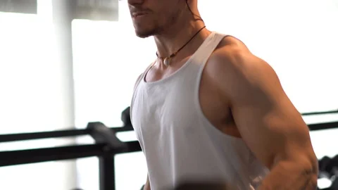 Closeup of man’s large muscles while curling heavy weights. Stock Footage 105243693