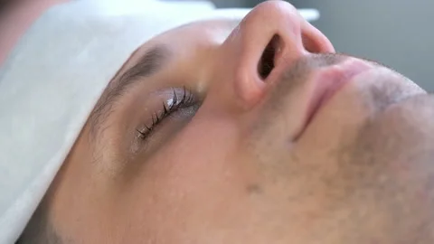 Closeup of man's lashes after lash laminating lifting procedure in beauty salon. Stock Footage 163803228