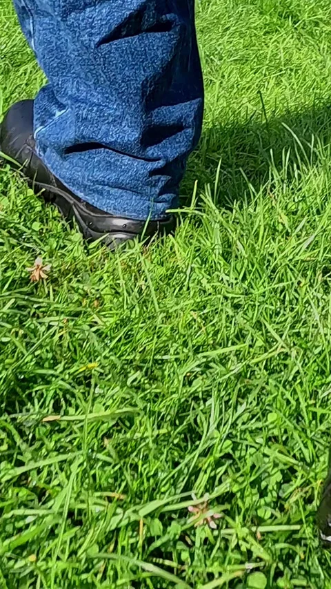 Closeup of mans legs stepping on grass in motion sequence Video stock 321653500