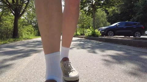 Closeup Mans Legs Walking Forward On Cement Pathway In Park 001 Video stock 249771980