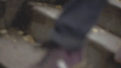 Closeup of man's shoes dancing down autumn leaf covered Paris stairs in Stock Footage 101303221