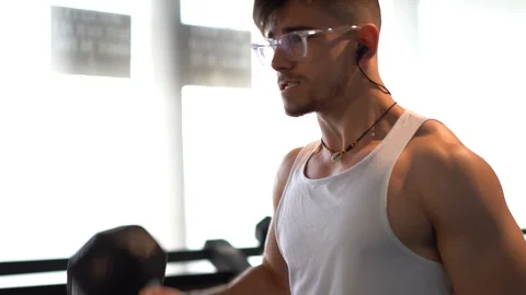 Closeup of man’s straining face while curling heavy weights. Stock Footage 105244352