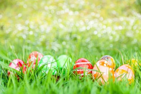 Closeup, many beautiful painted easter eggs as grass blurred background. co.. Stock Photos