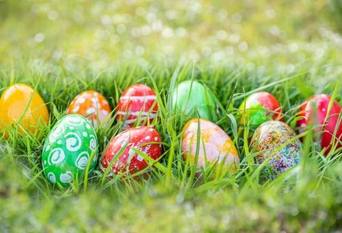Closeup, many beautiful painted easter eggs as grass blurred background. co.. Stock Photos