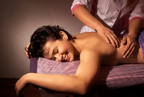 Closeup of massage on a pink background. Back massage. Spa salon. Spa body ma Stock Photos
