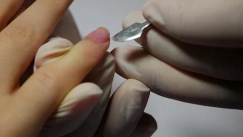 Closeup master of manicure corrects the base polish nails of female client Stock Footage 81397412