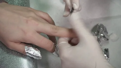 Closeup of master's hands clearing the gel polish Stock Footage 73417890