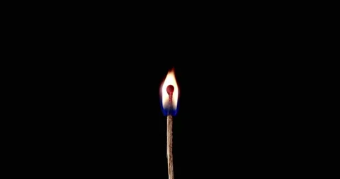 Closeup Match burning and combusting on black background. The match lights up Stock Footage 149206133