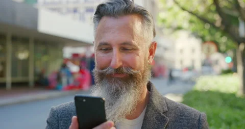 Closeup of mature man using phone to search fun activities in the city. Hipster 動画素材 201313834