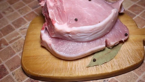 Closeup meat on a cutting board Stockbeeldmateriaal 102868847