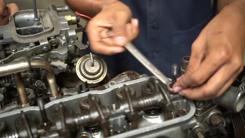 Closeup The mechanic is fixing the engine in the factory. Stock Footage 132121633