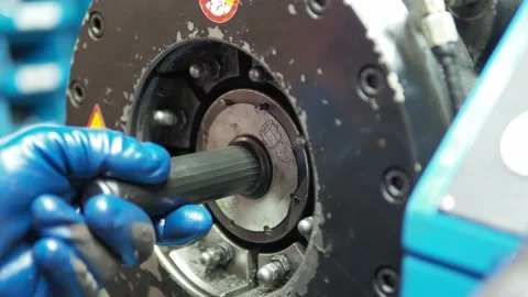 Closeup of mechanical man placing head inside crimping hose machine, static Video stock 197978372