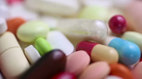 Closeup of medical pills turning in loop Video stock 24482566