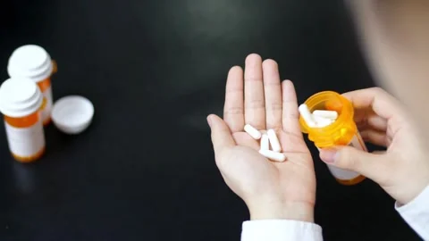 Closeup Of Medication Tablets Vitamins And Supplements. hand holding variety of Video stock 336586031