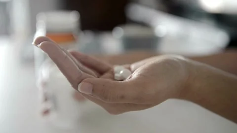Closeup Of Medication Tablets Vitamins And Supplements. hand holding variety of Video stock 336586065