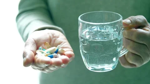 Closeup Of Medication Tablets Vitamins And Supplements. hand holding variety of Video stock 336586134