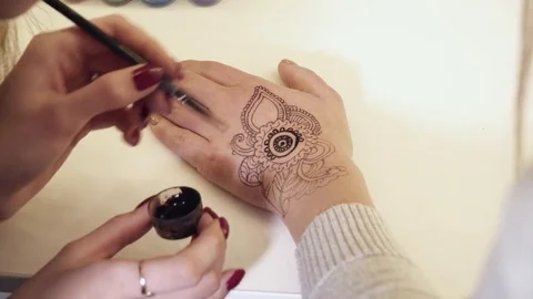 Closeup of the mehendi creation with a paint brush Stock Footage 73576759
