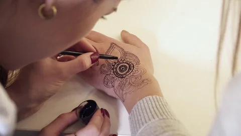 Closeup of the mehendi creation process with a brush Stock Footage 73577058