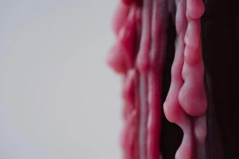 Closeup of melted red wax texture on light background 스톡 사진