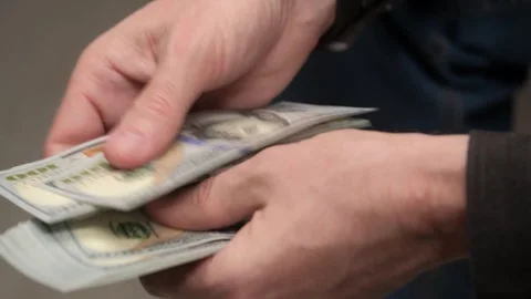 Closeup of men hands counting stack of US banknotes for one hundred dollars. Stock Footage 242023846