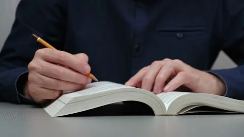 Closeup of men hands with pencil over book. study, search for useful information Stock Footage 221345409