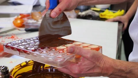 Closeup mens hands make molded bonbons Stock Footage 128228662