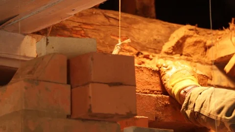 Closeup of men's hands making a wood-burning, rustic stove Stock Footage 123719889