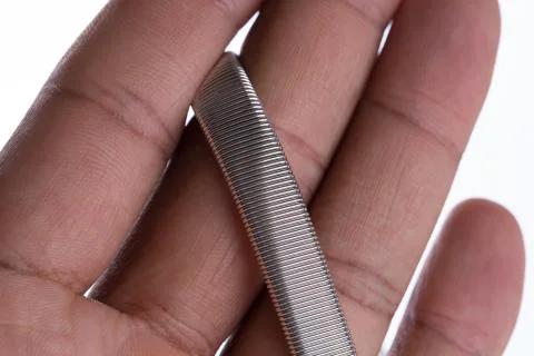 Closeup of metal braclet held around fingers 스톡 사진