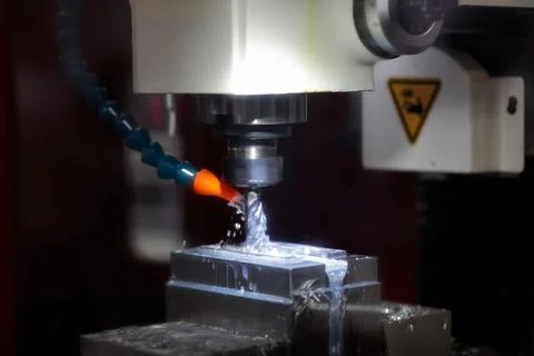 Closeup of metal milling process using CNC machine Stock Photos