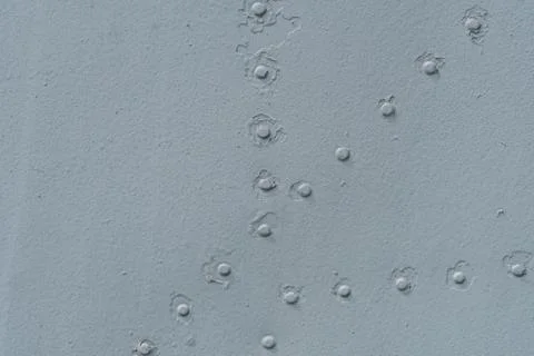 Closeup of metal with rows of rivets. Stock Photos