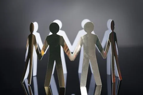 Closeup of metal team representing unity isolated over black background Stock Photos