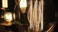 Closeup of metal wire inside illuminated Edison light bulb, vintage objects HD Footage