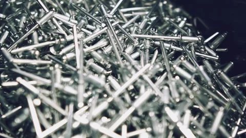 Closeup of metallic new rivets in a container. Stock Footage 98556483
