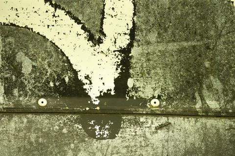 Closeup of a metallic surface with a white arrow on it Stock Photos