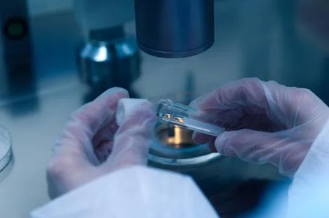 Closeup of microbiologist's hand opening test tube Stock Photos