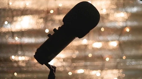 Closeup of microphone with blurred lights at background. Vídeos de archivo 122205392