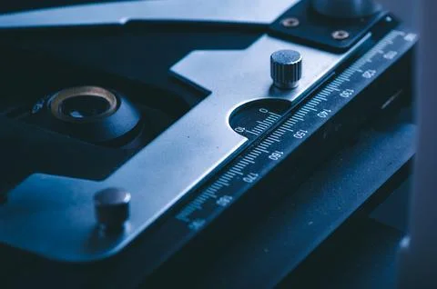 Closeup of microscope with metal lens, data analysis in the laboratory, sci.. Stock Photos