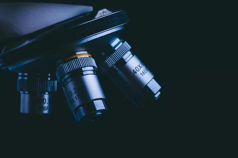 Closeup of microscope with metal lens, data analysis in the laboratory, sci.. Stock Photos