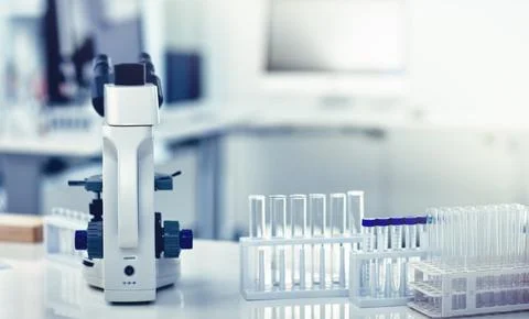 Closeup of microscope, test tubes and pipettes or droppers in medical, science Stock Photos